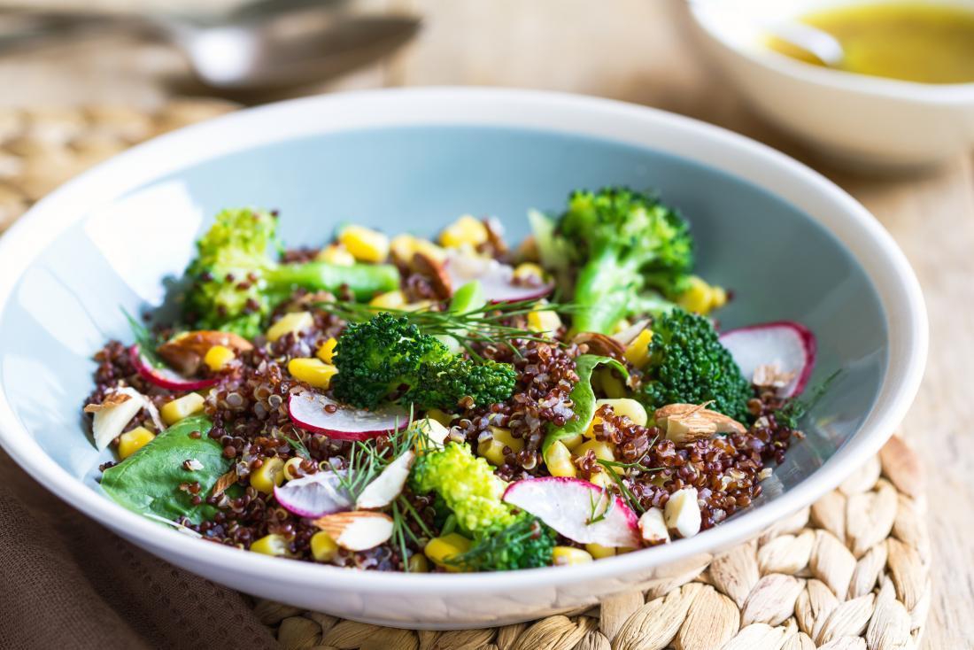 Broccoli salad in bowl with quinoa and radish and sweetcorn.